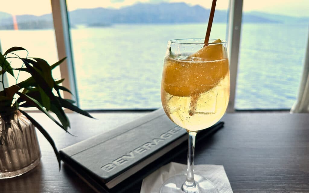 A cocktail with a view of the ocean behind.