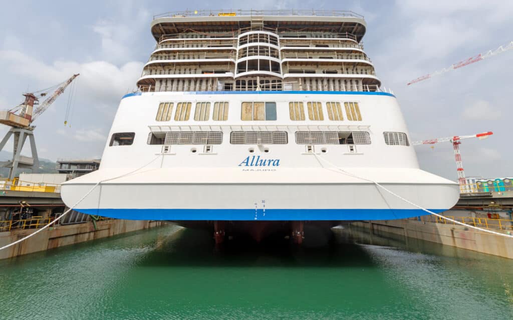 The Allura cruise ship in a dry dock filling with sea water.