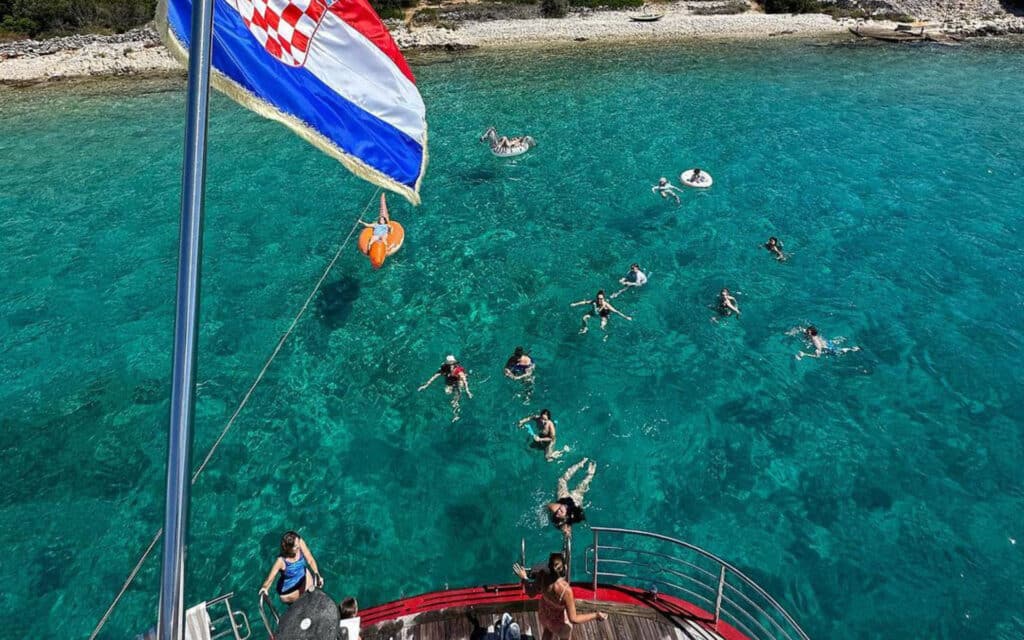 Guests enjoy a swim from the back of the vessel.