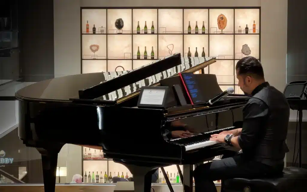 A pianist plays in the Lobby Bar on the Explora I cruise ship.