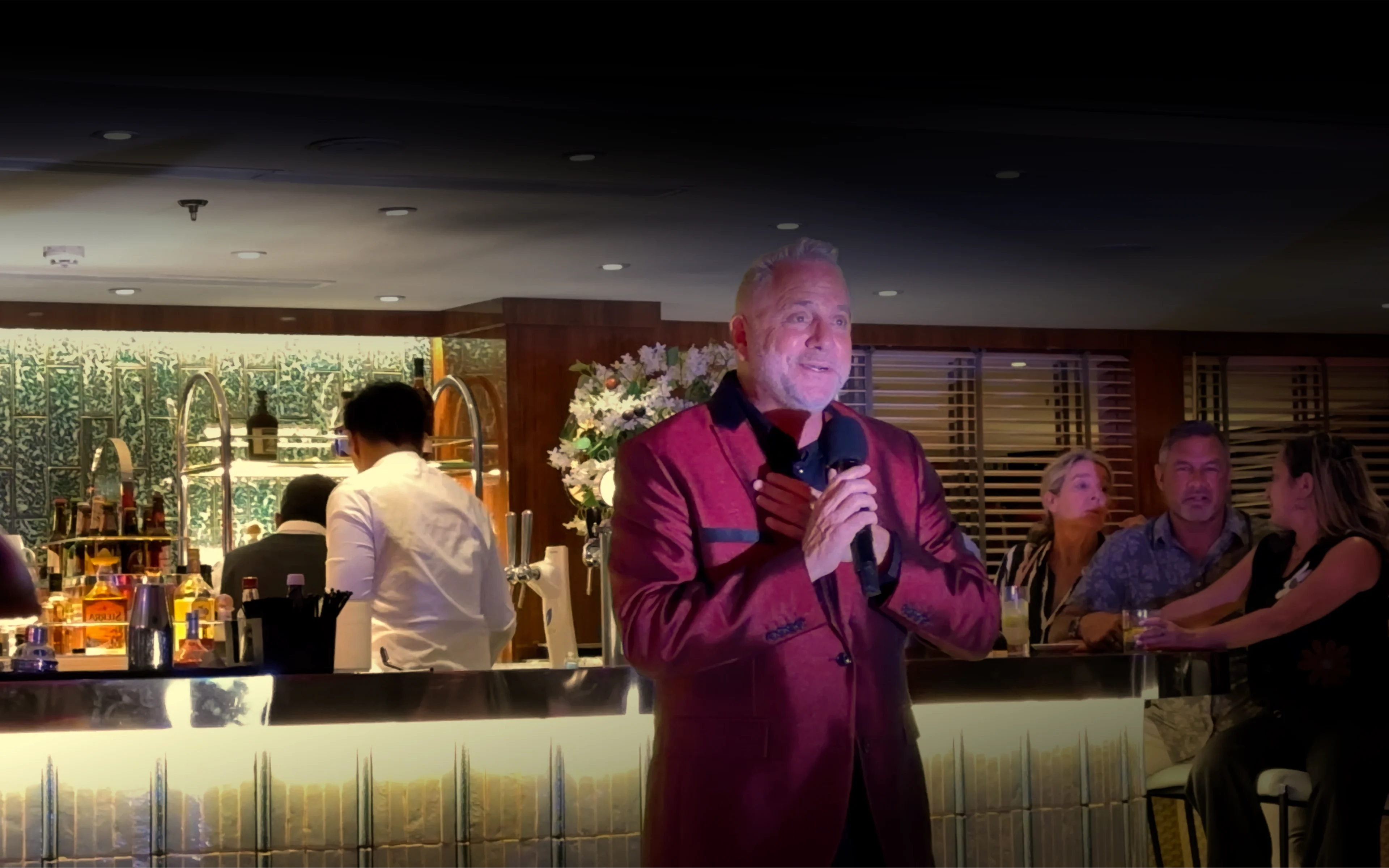 An entertainer sings in the Dome Observation Lounge on board World Traveller.