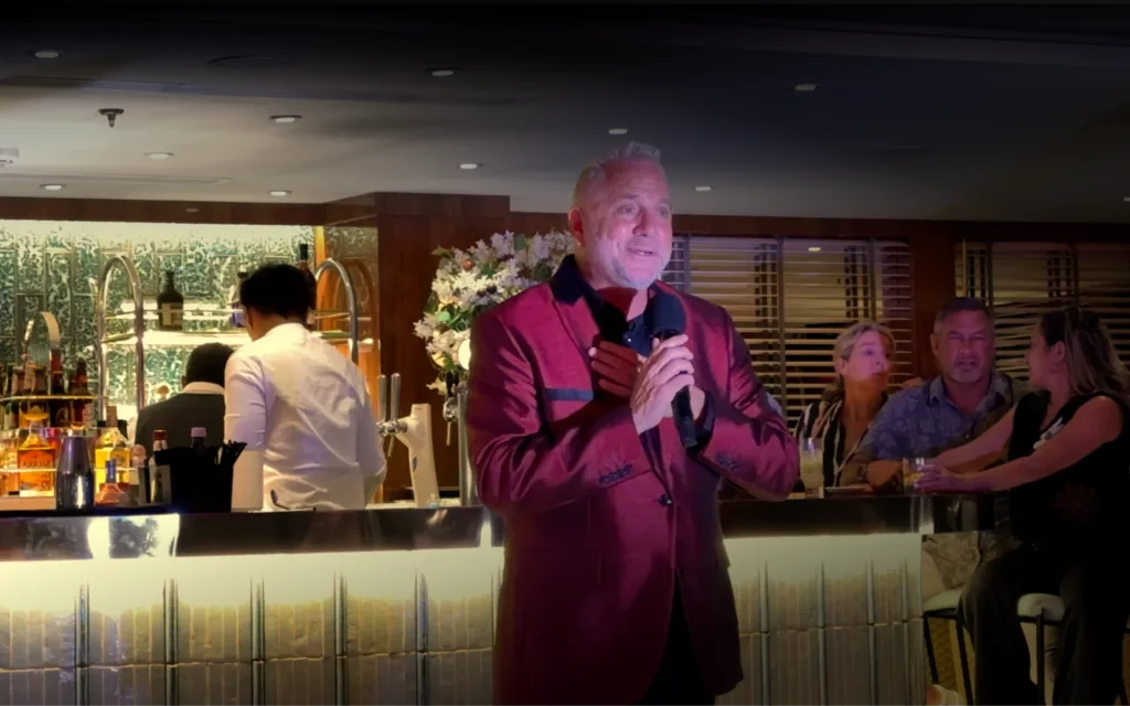 An entertainer sings in the Dome Observation Lounge on board World Traveller.