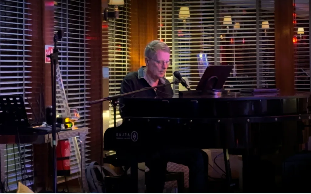 A pianist on board World Traveller.